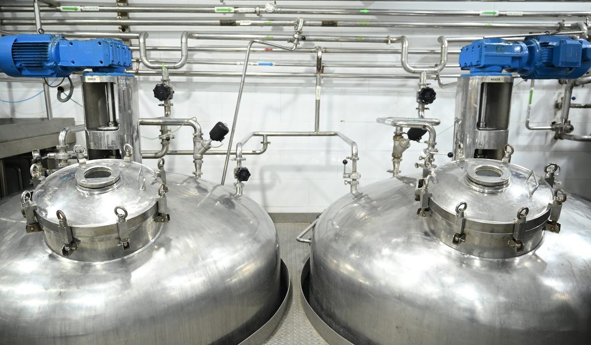 Two stainless mixing vessels with their agitator drives
